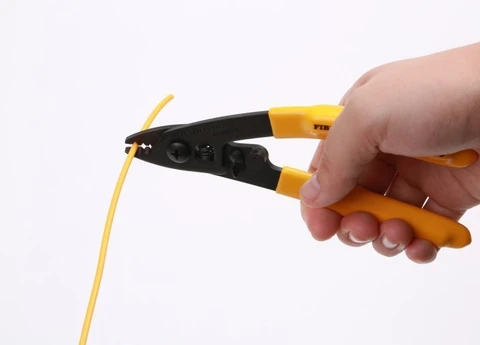 Three-hole fiber optic stripper tool in action