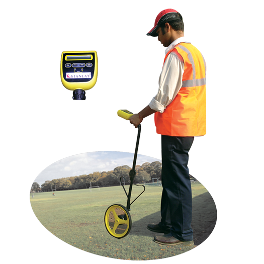 Technician using a measuring wheel on a construction site